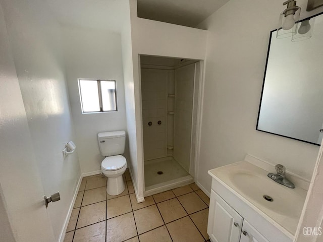 bathroom with tile patterned floors, vanity, toilet, and tiled shower