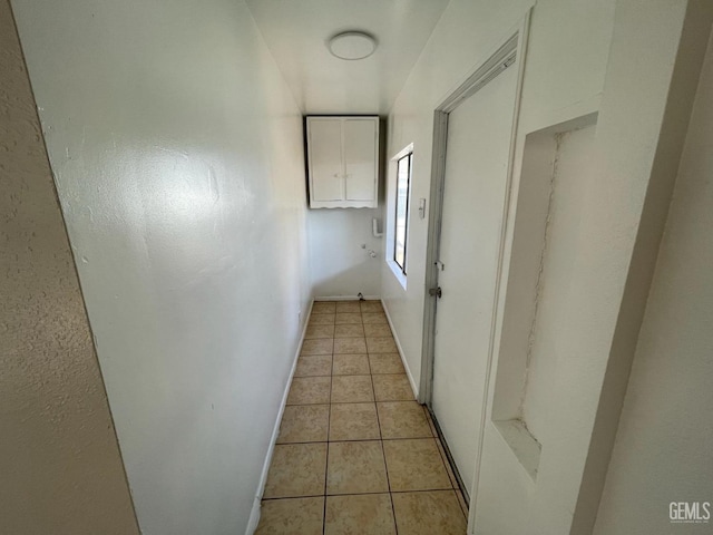 hall featuring light tile patterned flooring