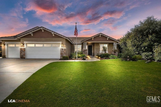 view of front of home with a garage and a yard