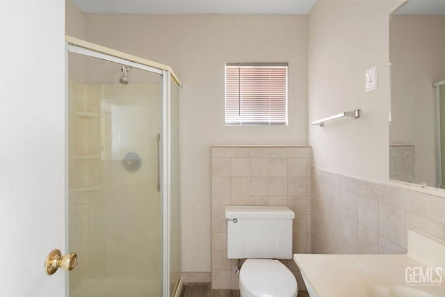 bathroom featuring tile walls, vanity, toilet, and walk in shower