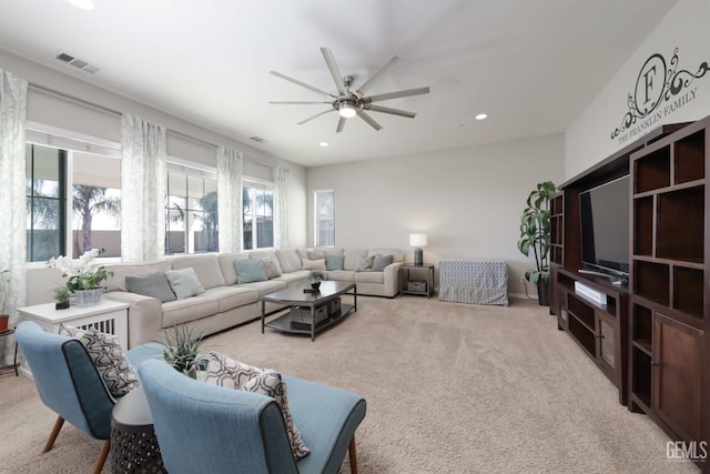 living room featuring ceiling fan and light carpet