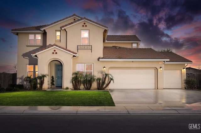 mediterranean / spanish-style house with a garage and a yard