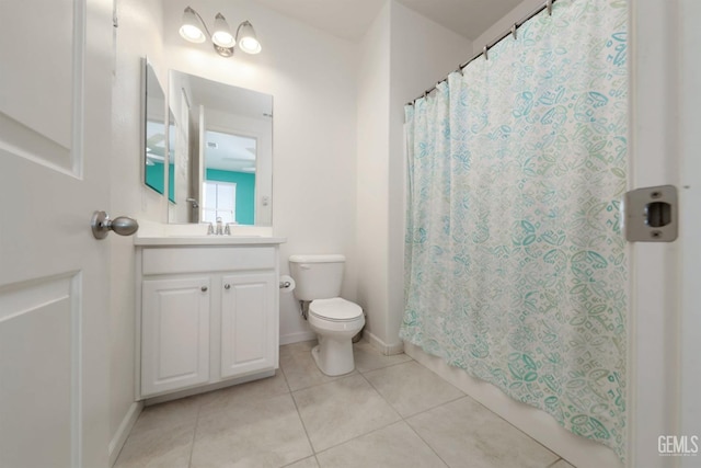 bathroom with toilet, vanity, tile patterned floors, and curtained shower