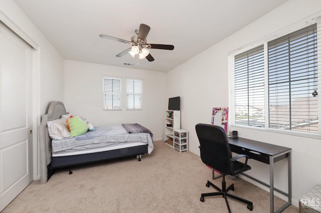 bedroom with ceiling fan and light colored carpet