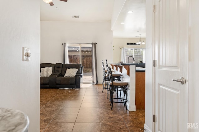 605 Cornelia St, Wasco, CA 93280 - dining area with ceiling fan and dark tile patterned floors
