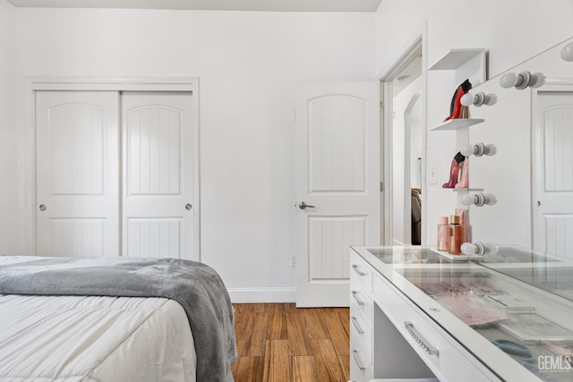 605 Cornelia St, Wasco, CA 93280 - bedroom featuring wood finished floors, a closet, and arched walkways