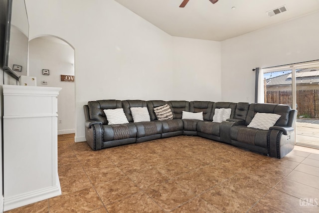 605 Cornelia St, Wasco, CA 93280 - living area featuring a ceiling fan, arched walkways, vaulted ceiling, and tile patterned flooring