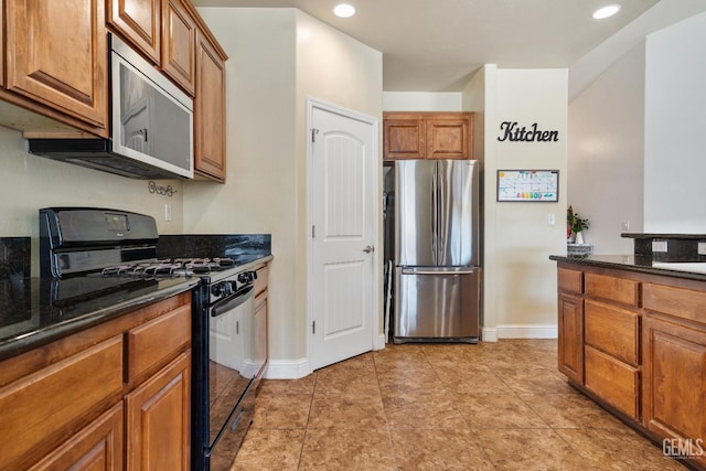 605 Cornelia St, Wasco, CA 93280 - kitchen featuring stainless steel appliances, brown cabinets, recessed lighting, and dark stone counters