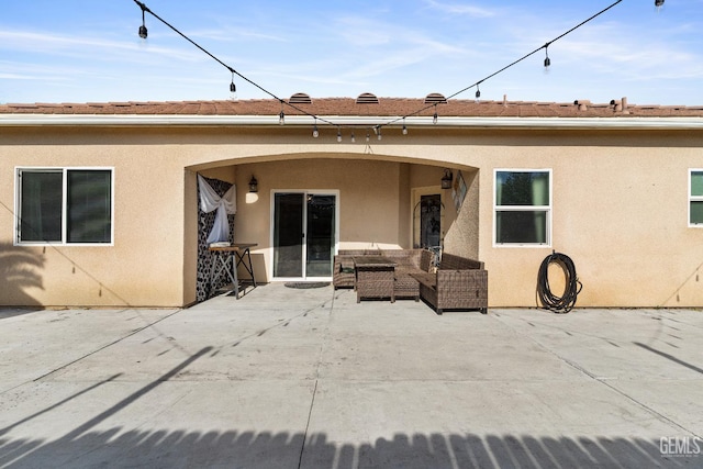 605 Cornelia St, Wasco, CA 93280 - rear view of property with stucco siding, an outdoor hangout area, and a patio