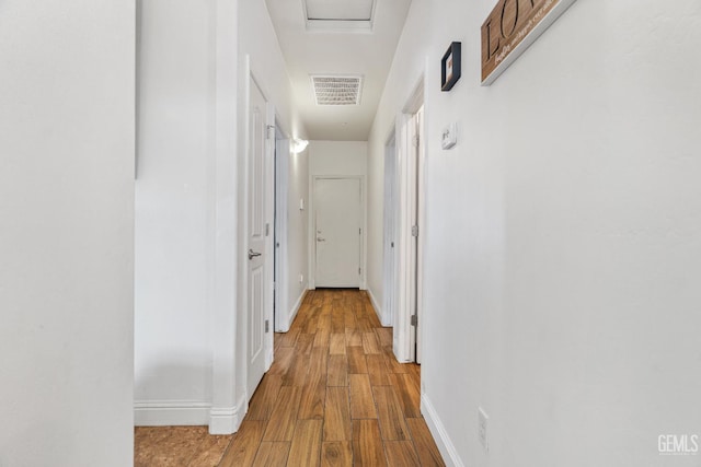 605 Cornelia St, Wasco, CA 93280 - corridor featuring wood finished floors and attic access