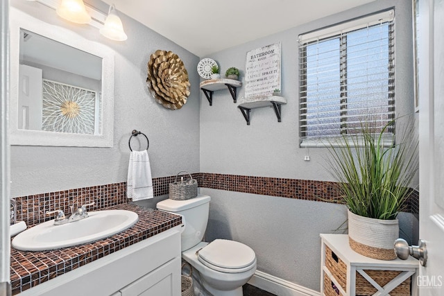 5104 Silver Crossing St, Bakersfield, CA 93313 - half bath featuring vanity, toilet, and tasteful backsplash