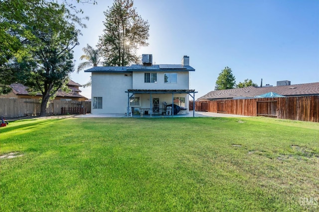 5104 Silver Crossing St, Bakersfield, CA 93313 - back of house with roof mounted solar panels, a patio, a chimney, central AC unit, and stucco siding
