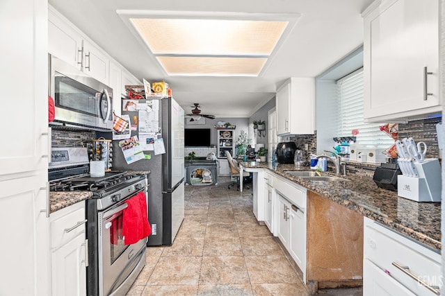 5104 Silver Crossing St, Bakersfield, CA 93313 - kitchen featuring stainless steel appliances, a sink, tasteful backsplash, white cabinetry, and a ceiling fan