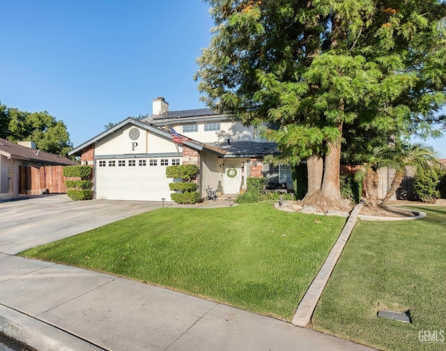 5104 Silver Crossing St, Bakersfield, CA 93313 - view of front of house with roof mounted solar panels, a front yard, a garage, driveway, and stucco siding