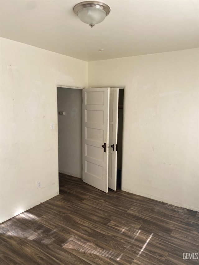 spare room featuring dark hardwood / wood-style floors