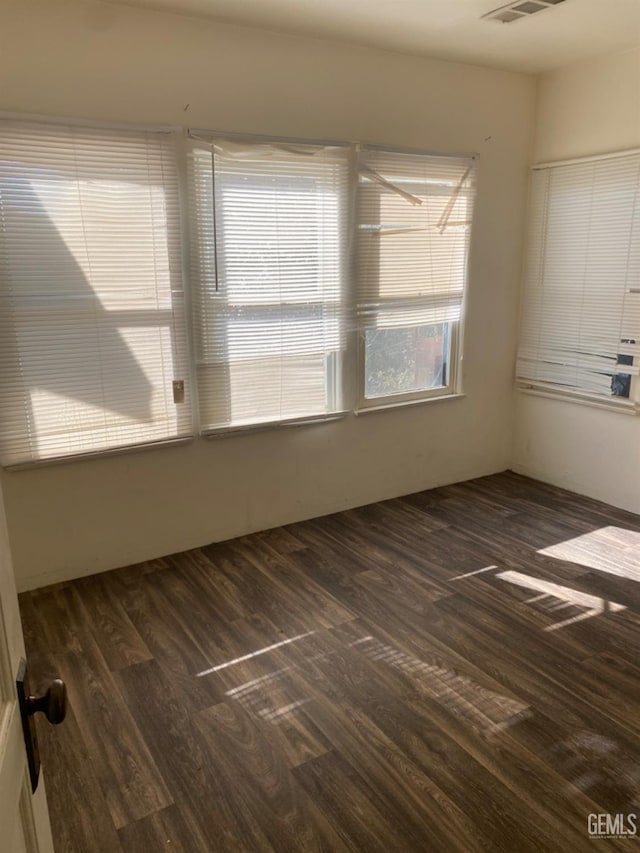 unfurnished room featuring dark hardwood / wood-style flooring