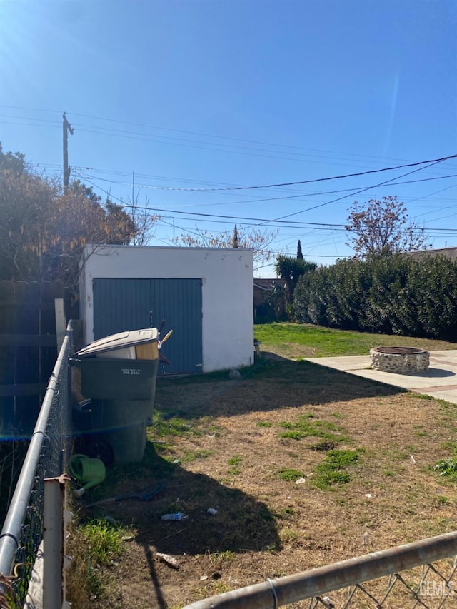 view of yard with an outdoor fire pit