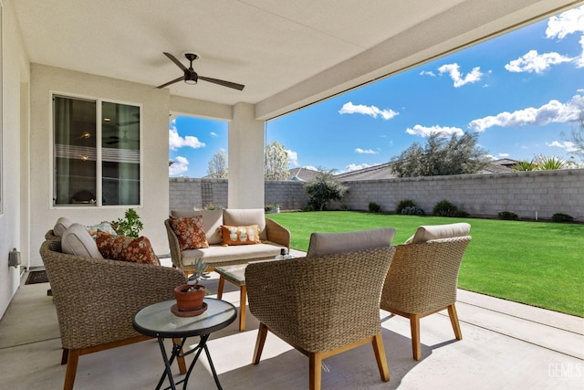 view of patio / terrace with an outdoor living space, a fenced backyard, and ceiling fan