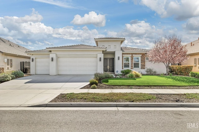 view of front of house with a front yard, driveway, stucco siding, a garage, and a tile roof