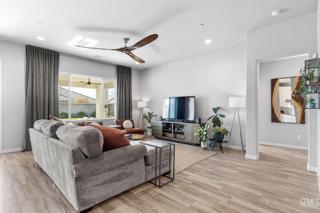 living room with recessed lighting, light wood-style flooring, a ceiling fan, and baseboards