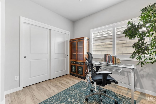 home office featuring baseboards and wood finished floors