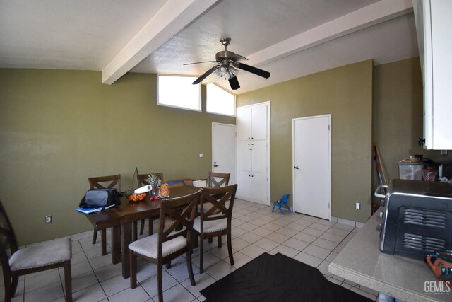 dining space featuring vaulted ceiling with beams, ceiling fan, and light tile patterned flooring