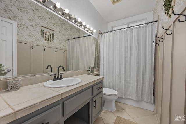 full bathroom with tile patterned flooring, vanity, shower / tub combo, and toilet