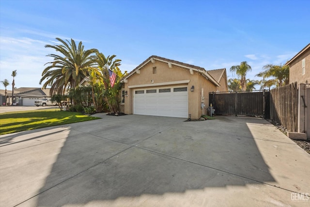 view of side of home featuring a yard and a garage