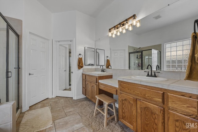 bathroom featuring vanity and a shower with shower door