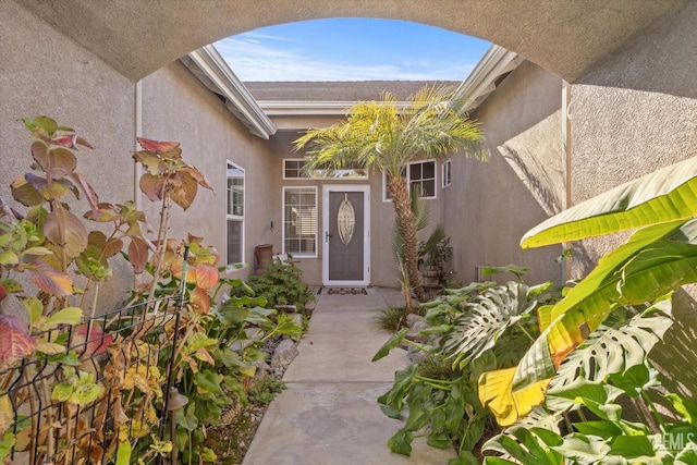 view of exterior entry with a patio