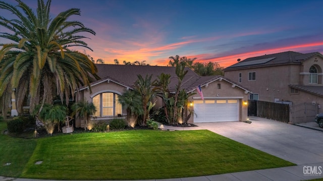 view of front of house with a yard and a garage