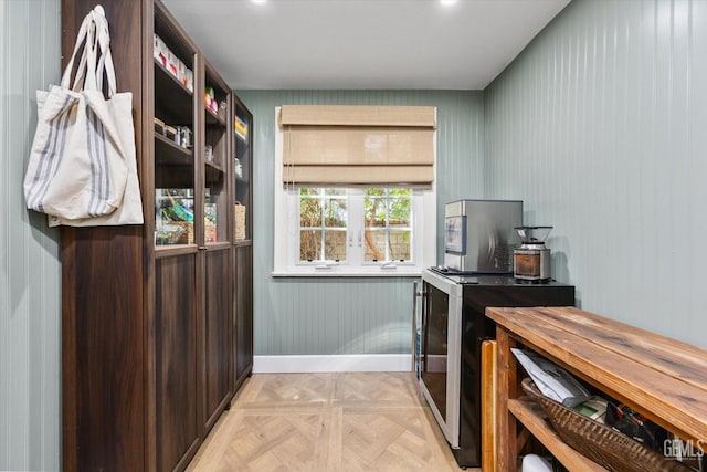 kitchen featuring beverage cooler and baseboards