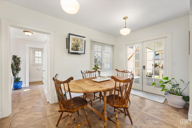 dining area featuring french doors and baseboards