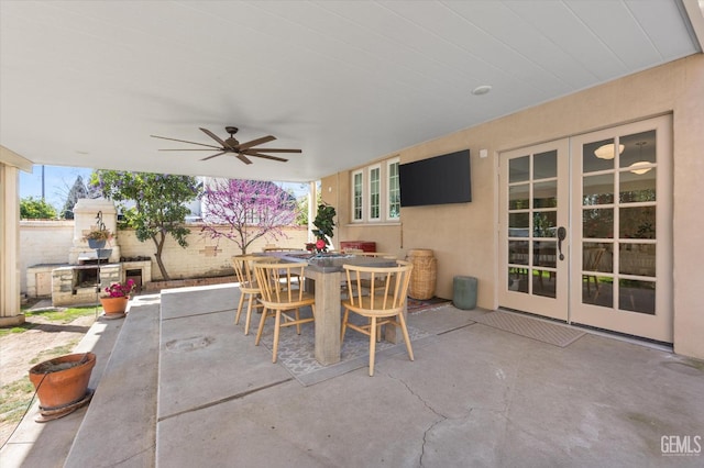 view of patio / terrace featuring outdoor dining space, french doors, and ceiling fan