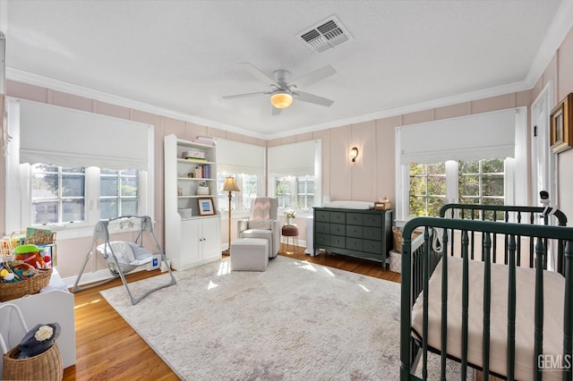 bedroom with visible vents, multiple windows, and ornamental molding