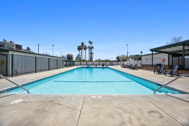 pool featuring a patio and fence