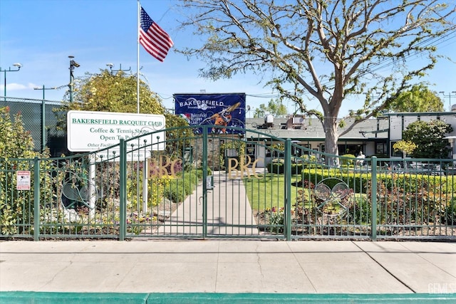 view of home's community featuring fence and a gate