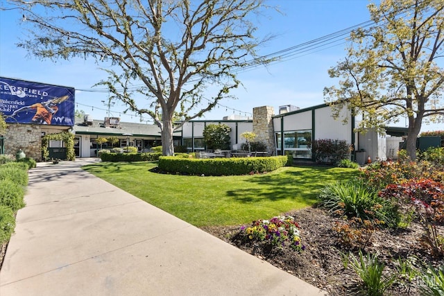 view of home's community with a lawn