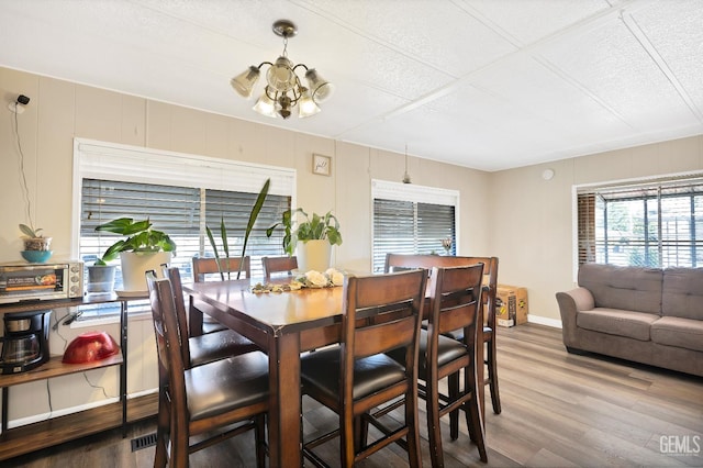 3601 S Chester Ave Unit 12, Bakersfield, CA 93304 - dining area featuring a chandelier, wood finished floors, and a textured ceiling