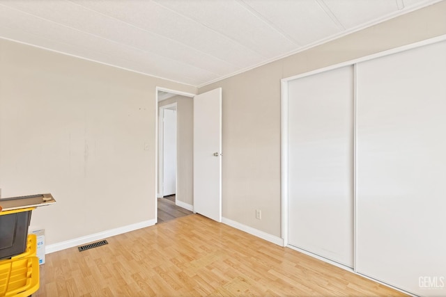 3601 S Chester Ave Unit 12, Bakersfield, CA 93304 - unfurnished bedroom featuring light wood-style floors and a closet
