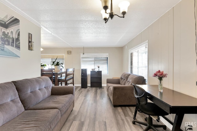 3601 S Chester Ave Unit 12, Bakersfield, CA 93304 - living area featuring a chandelier, light wood-style floors, healthy amount of natural light, and a textured ceiling