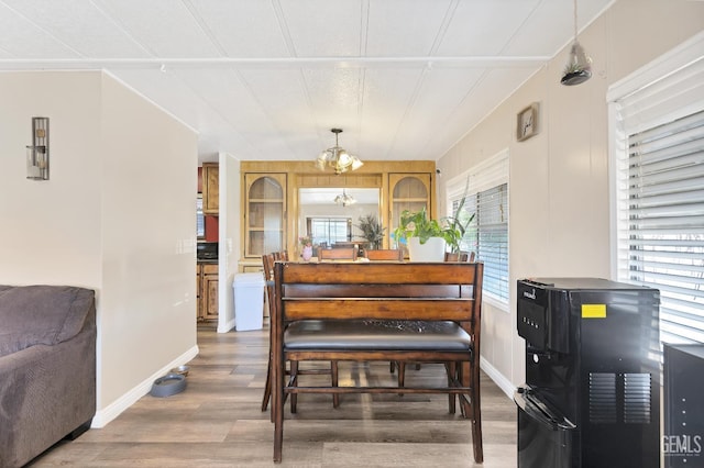 3601 S Chester Ave Unit 12, Bakersfield, CA 93304 - dining space with a chandelier and wood finished floors