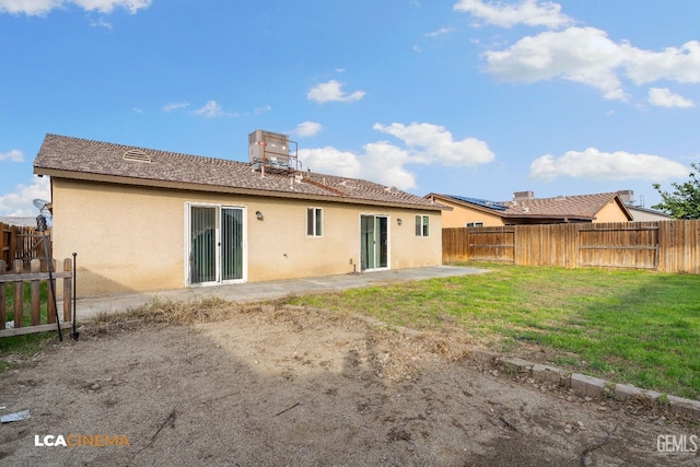 back of property featuring a patio area and a lawn