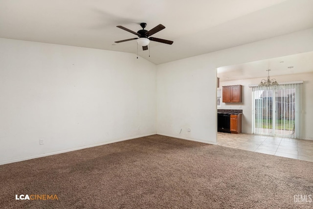 unfurnished living room with ceiling fan with notable chandelier, light colored carpet, and vaulted ceiling