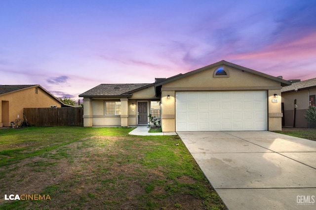 single story home featuring a lawn and a garage