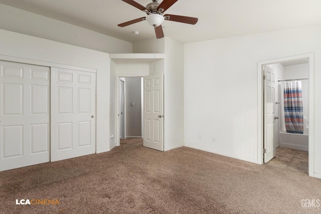 unfurnished bedroom featuring a closet, light colored carpet, ensuite bath, and ceiling fan