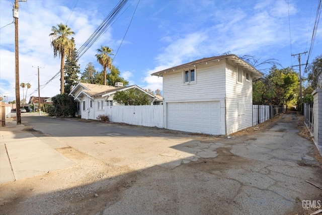 view of side of home featuring fence