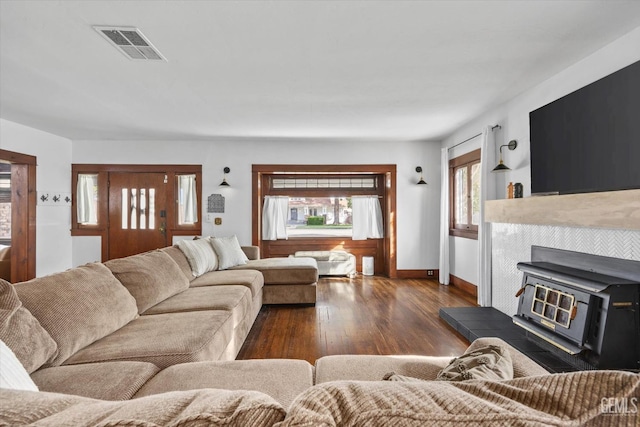 living room with baseboards, visible vents, and dark wood-style flooring