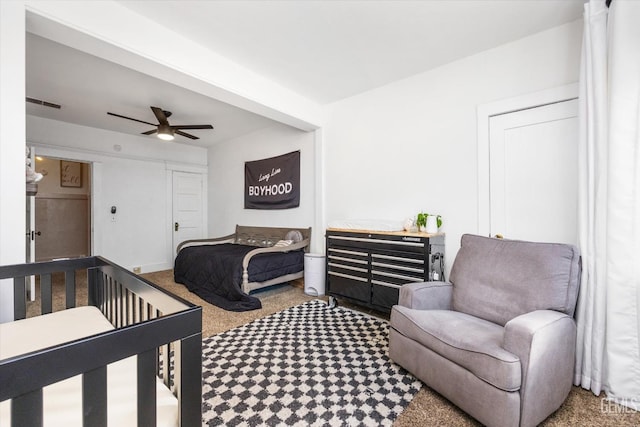 carpeted bedroom featuring visible vents and ceiling fan