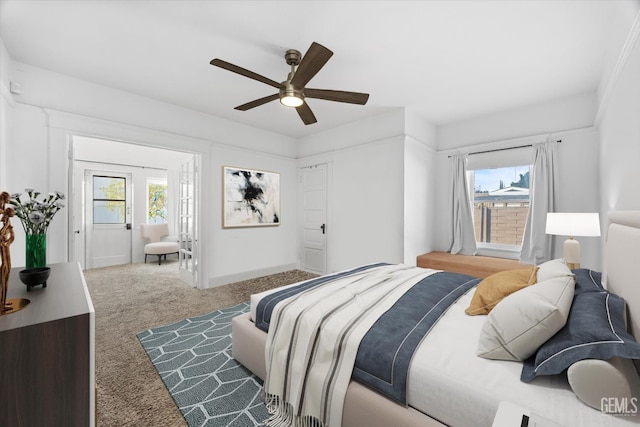 bedroom with carpet floors, multiple windows, and a ceiling fan